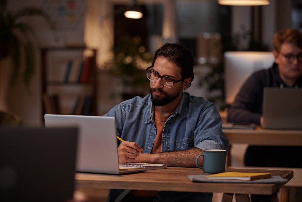 Man working on a case study on a laptop