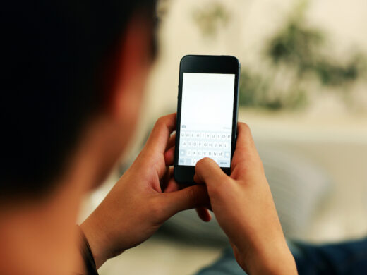 Closeup portrait of a man using smartphone.