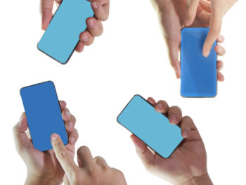 Four hands holding mobile smart phone with blank screen.
