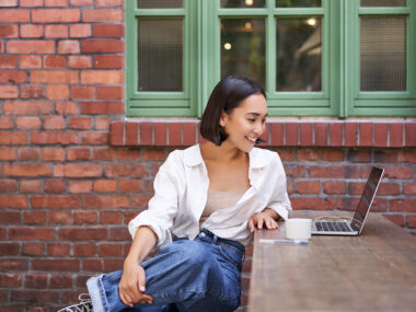 Young woman using laptop to earn money through affiliate marketing